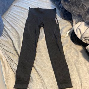 Dark grey gym shark leggings with hole detailing at the bottom.